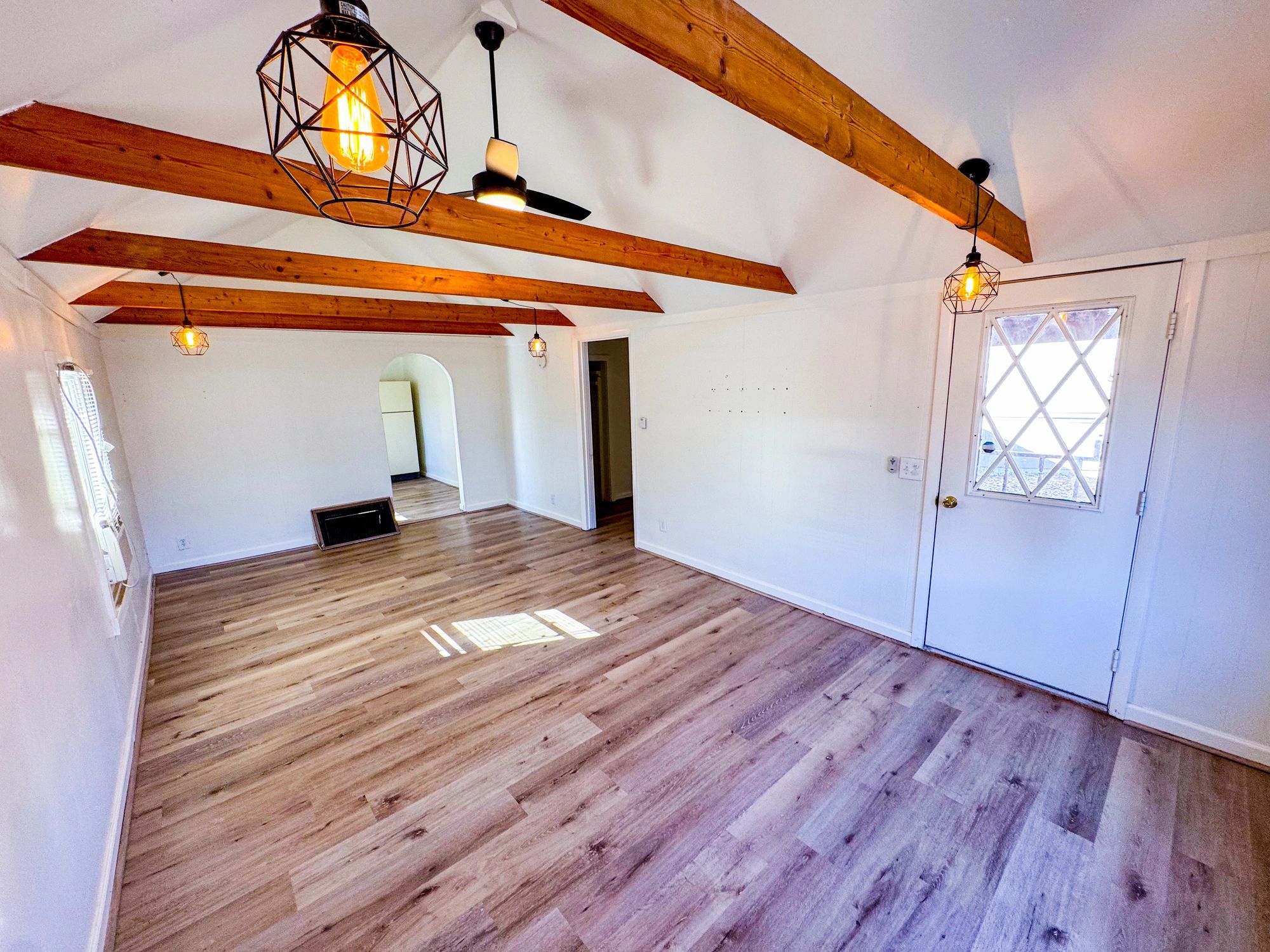 Living room with vinyl plank flooring and exposed beams in Hawaii